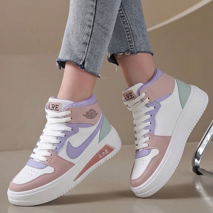 A pair of pastel high-top sneakers worn with light-wash denim jeans. The shoes feature white, dusty pink, lavender purple, and mint green panels with white laces and thick white soles.