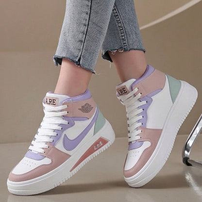 A pair of pastel high-top sneakers worn with light-wash denim jeans. The shoes feature white, dusty pink, lavender purple, and mint green panels with white laces and thick white soles.