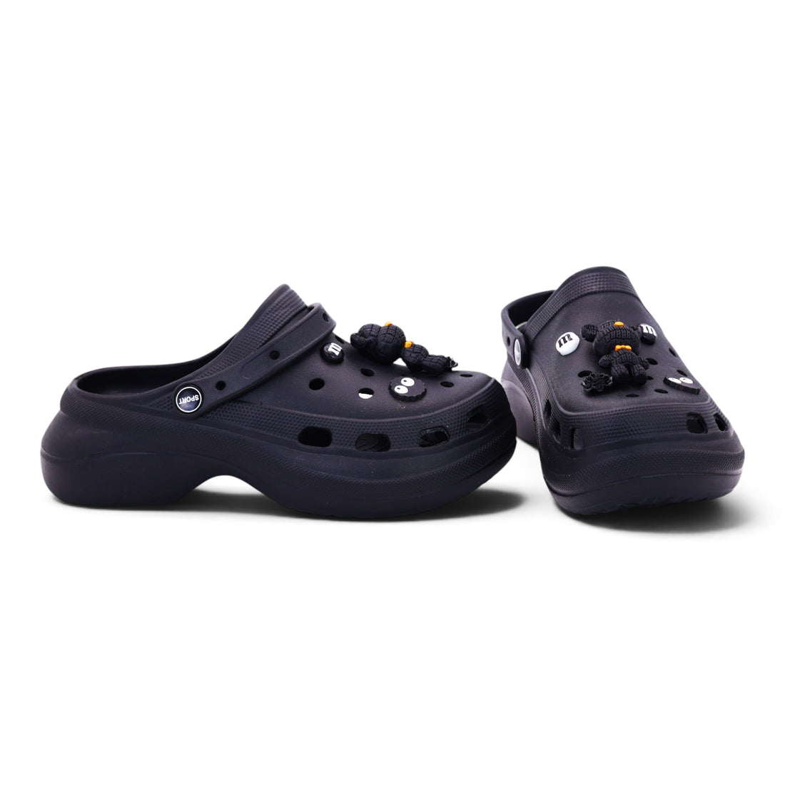 A pair of black platform clogs decorated with small black and white skull charms and colorful bead tassels, displayed on a clean white background.