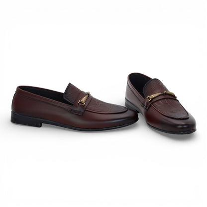 Pair of brown loafers with gold accents on a white background